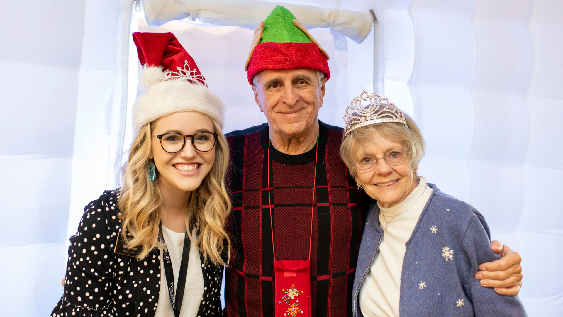 Rachel Grant, The Village of Bedford Walk Concierge & Marketing Associate, poses with residents at the community’s 2018 holiday party.
